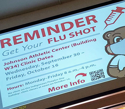 Infinite Display screen showing a reminder to get your flu shot.